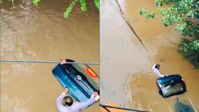 Watch: Man refuses to leave his car behind amid chest-level floodwaters; heart-wrenching video goes viral | Delhi News